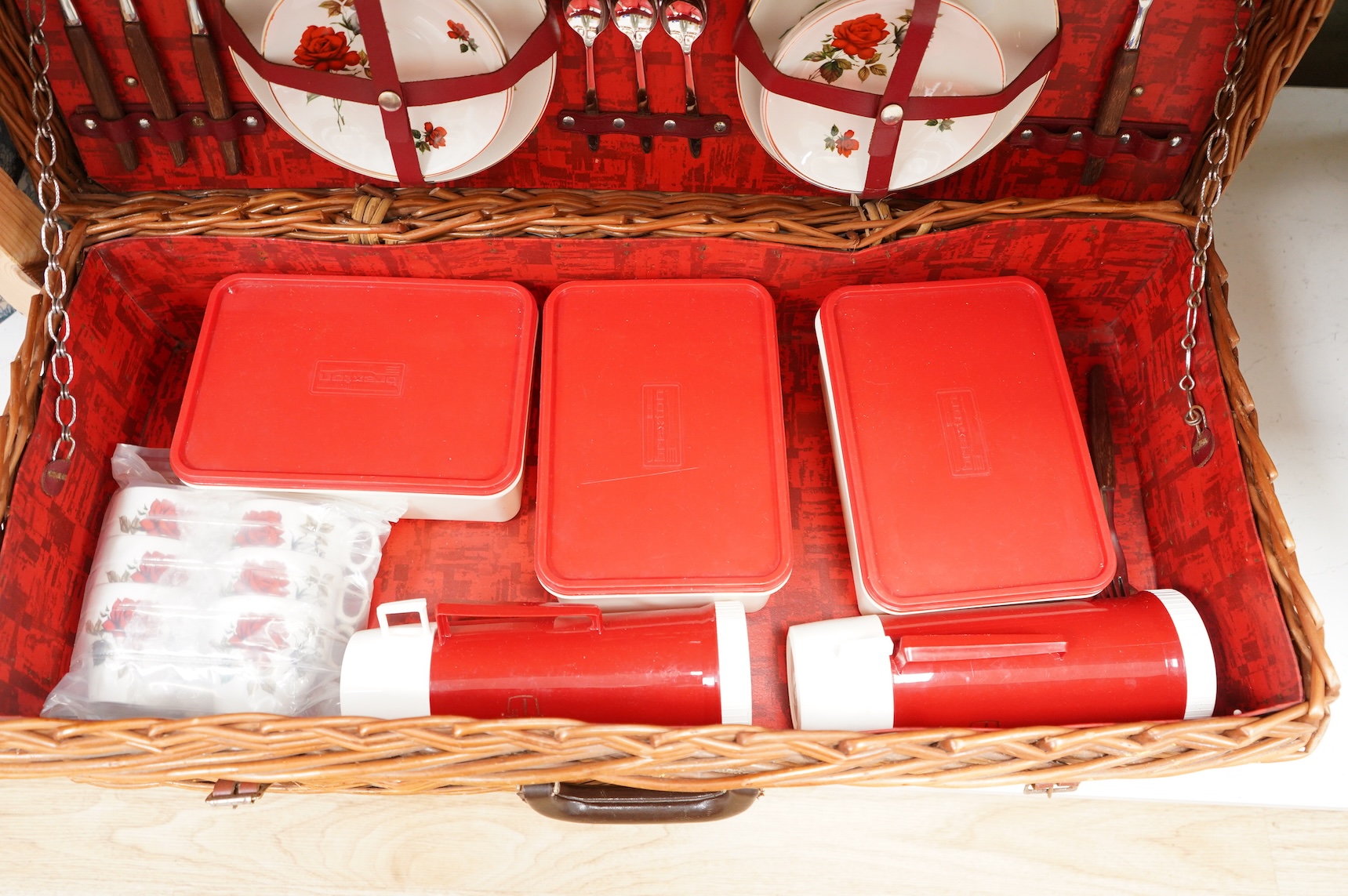An Asprey wicker picnic basket, fully fitted with contents